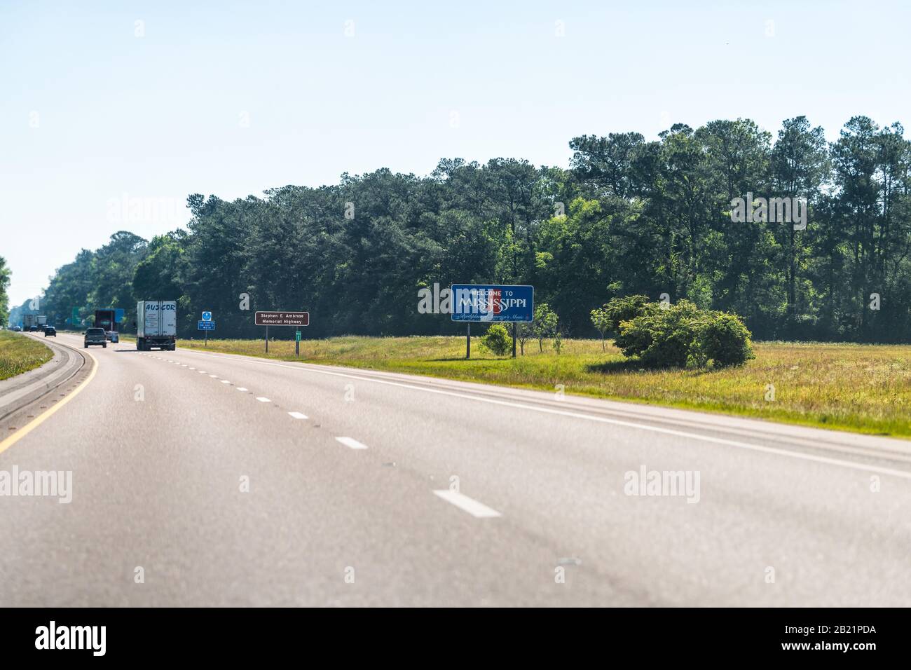 Pearlington, USA - April 24, 2018: Welcome to Mississippi road sign with cars on highway interstate i10 at border with Louisiana Stock Photo