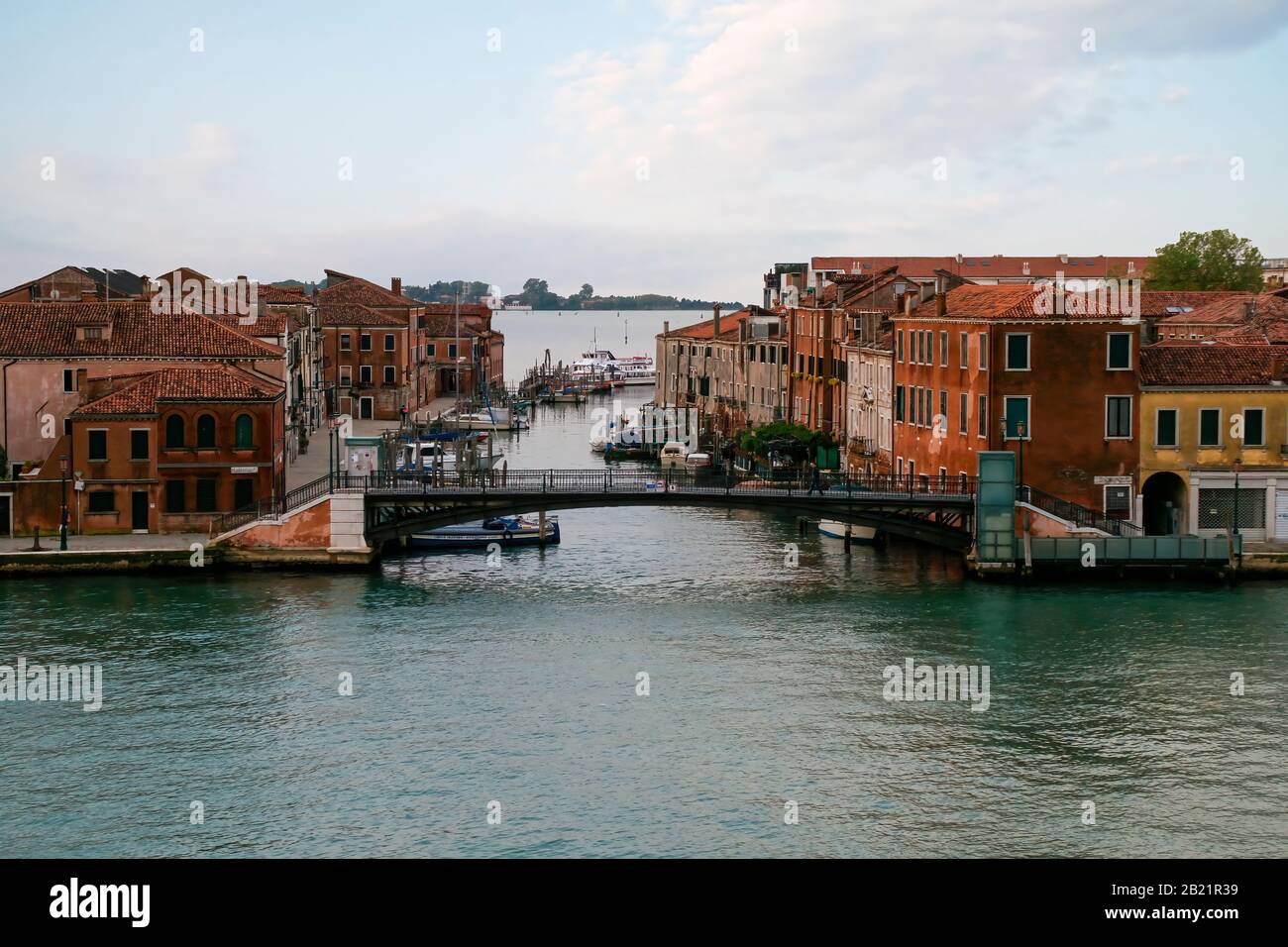 Houses, businesses, boats, and bridges as seen from the canal Giudecca. Early morning before the area gets busy. Stock Photo