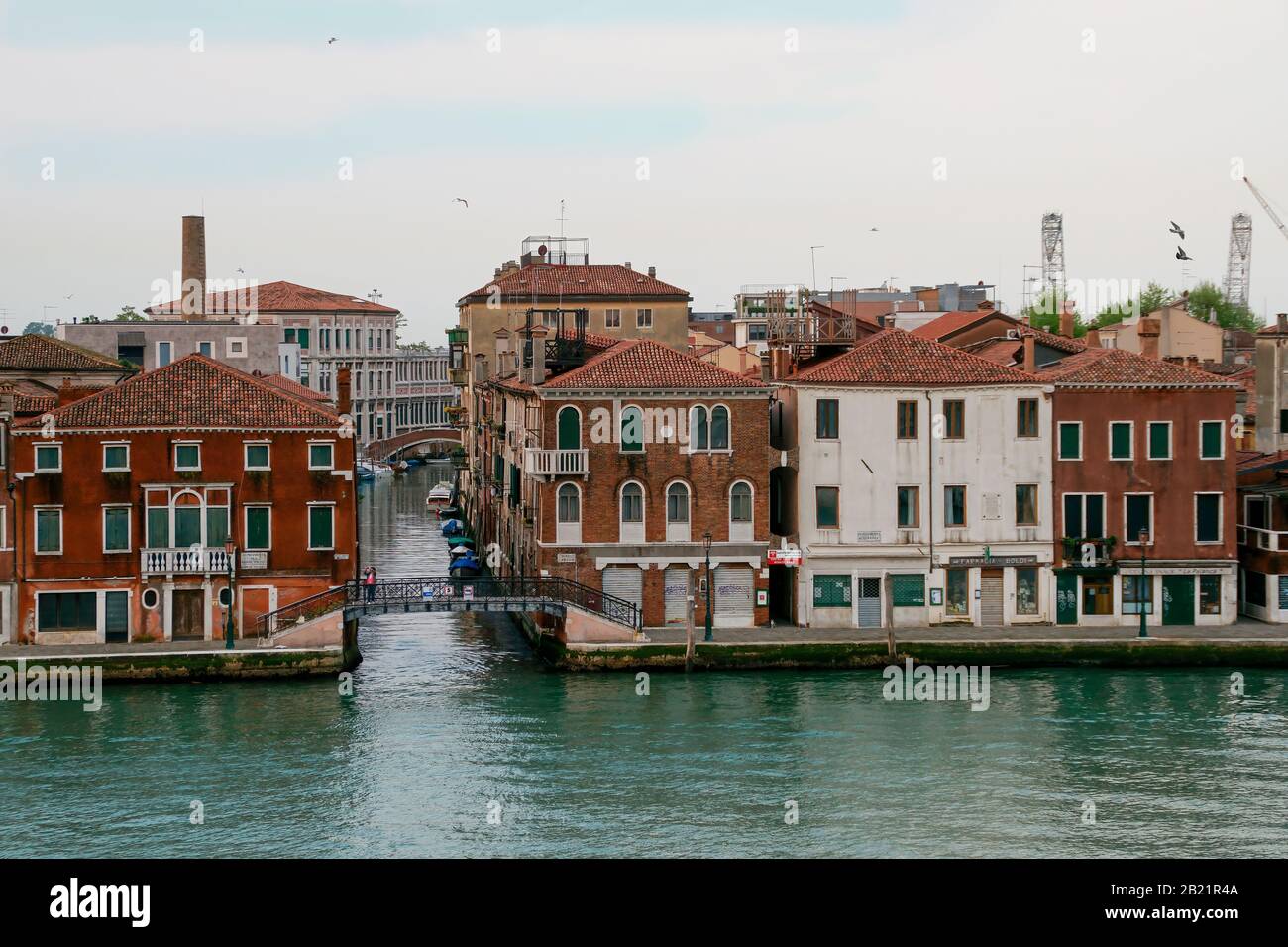 Houses, businesses, boats, and bridges as seen from the canal Giudecca. Early morning before the area gets busy. Stock Photo