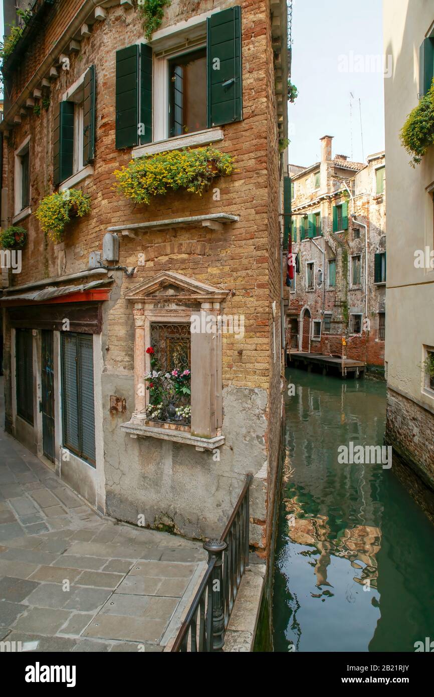 A triangular shaped building between an alley and a small back canal; Stock Photo