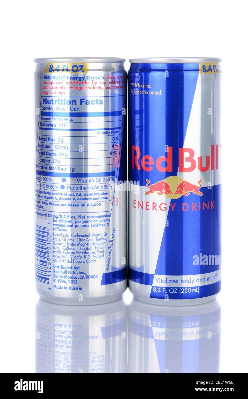 IRVINE, CA - February 06, 2014: Front and bacl of two Red Bull Energy Drinks. Red Bull is the most popular energy drink in the world, with 5.2 billion Stock Photo