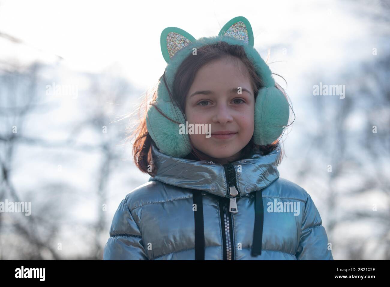 Beautiful young cute woman in blue coat is posing. Fashion trendy style  clothes. Beautiful girl outdoors in winter in a blue jacket. 9 years old.  Girl Stock Photo - Alamy