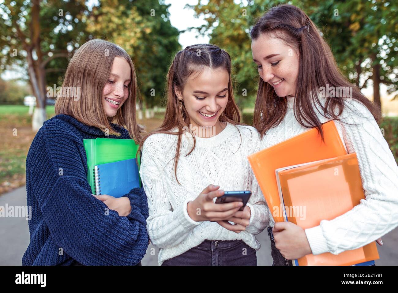 3 girls teenagers, smartphone. Holiday weekend, best friends ...