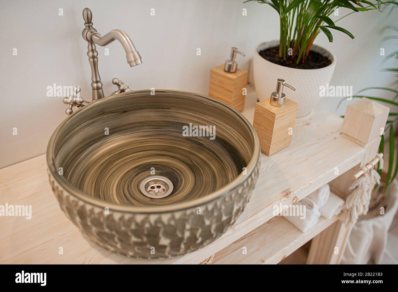 Round Dark Unusual Stone Sink On A Wooden Countertop And Reusable