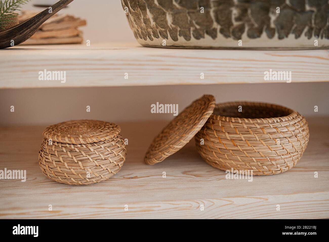 two woven straw baskets for storage in boho style Stock Photo Alamy