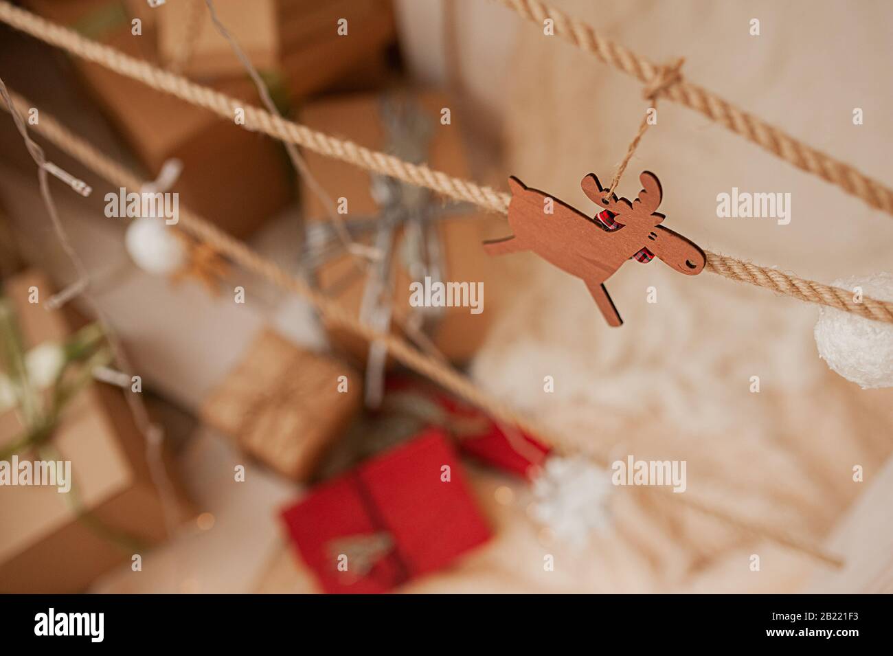 wooden toy deer on a modern tree made of wood and ropes Stock Photo - Alamy
