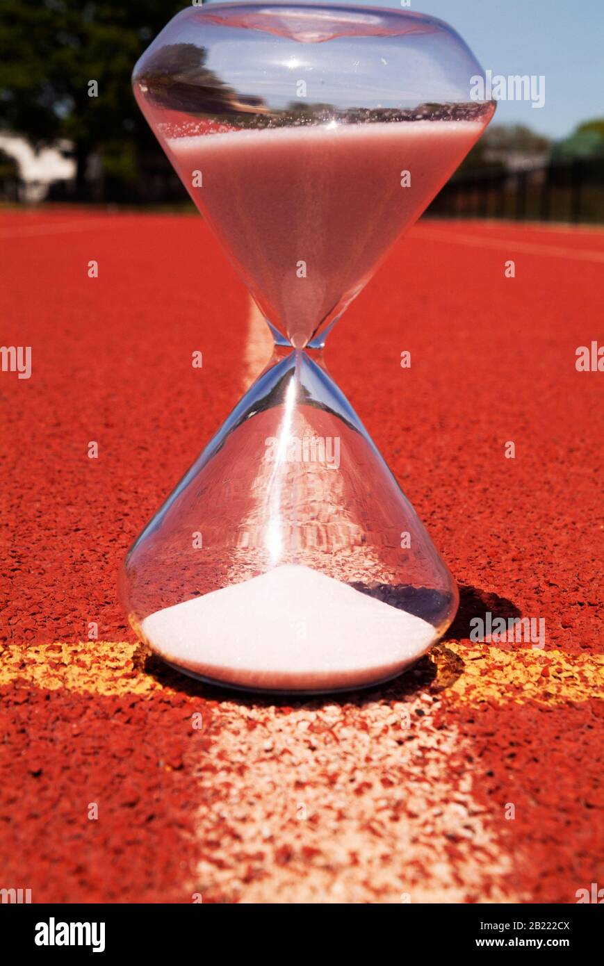 TIMELINE: An hourglass sits on a high school racetrack. Stock Photo