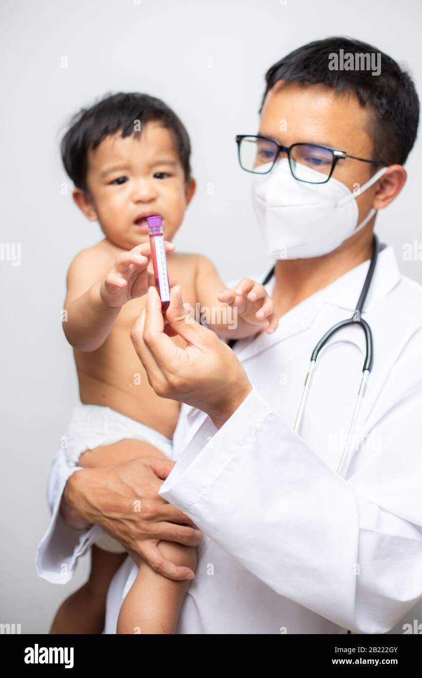 Doctor holding asian baby boy with Coronavirus (COVID19) Blood in