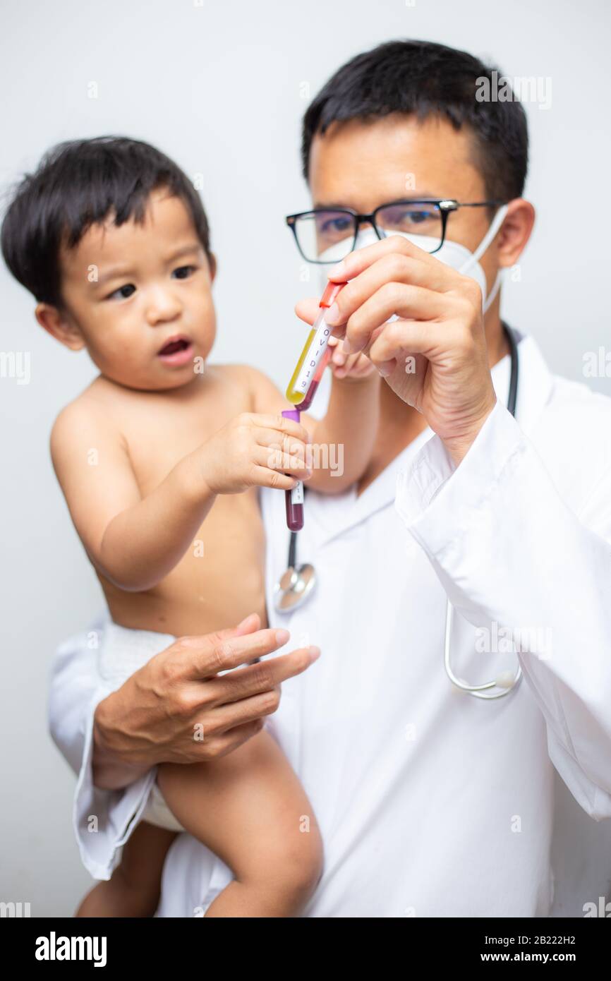 Doctor holding asian baby boy with Coronavirus (COVID19) Blood in