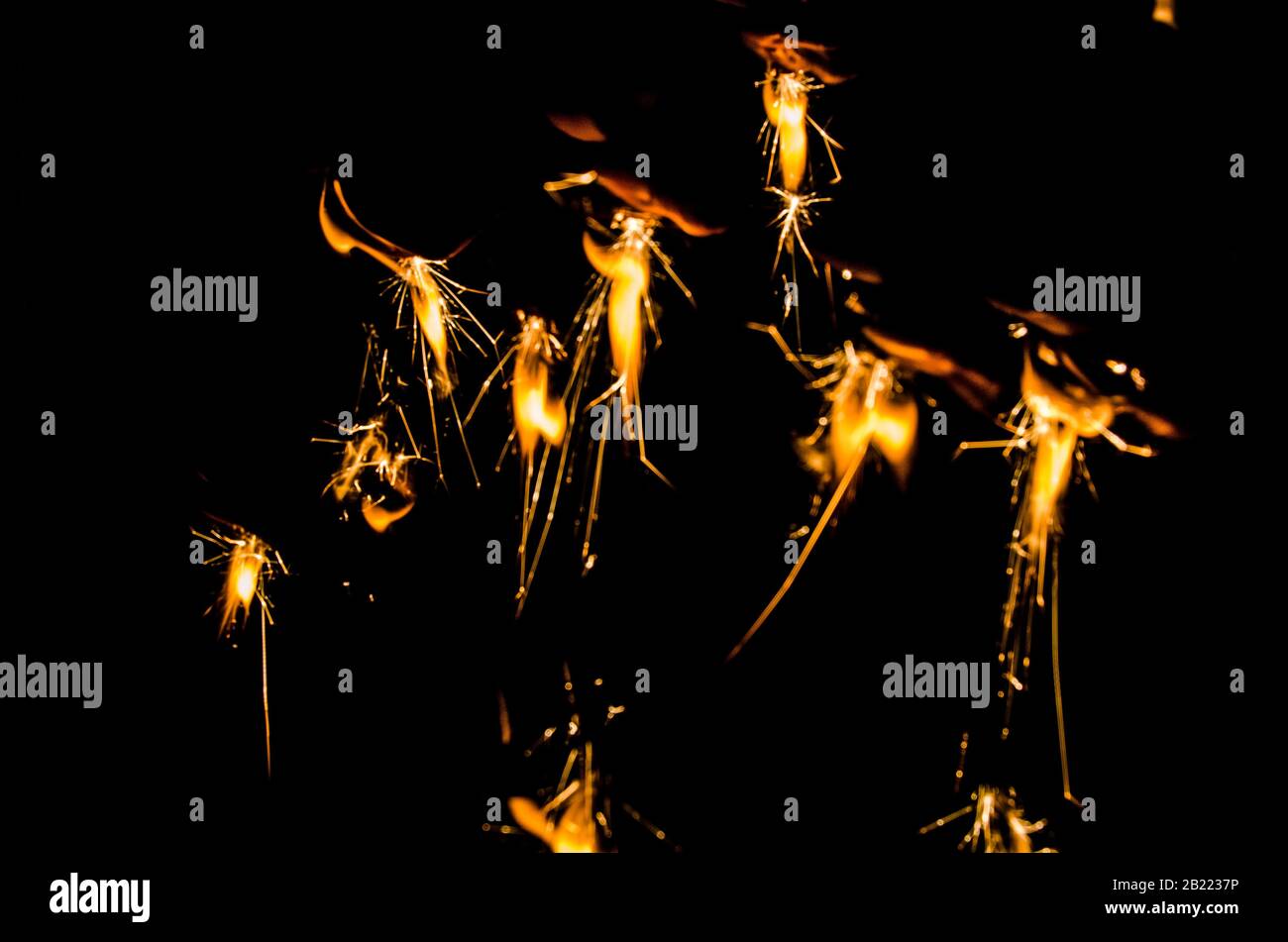 Bright yellow fire sparks on black background Stock Photo Alamy