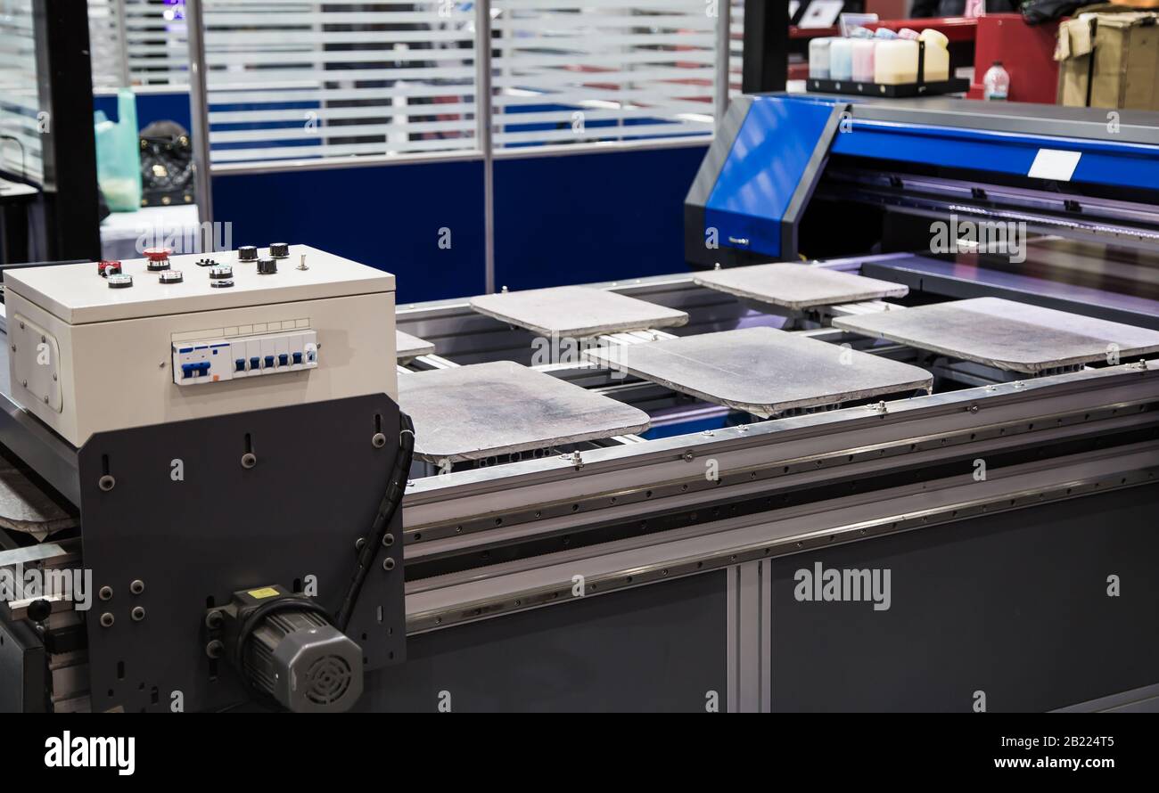 T-shirt digital printing machine in garment industry Stock Photo - Alamy