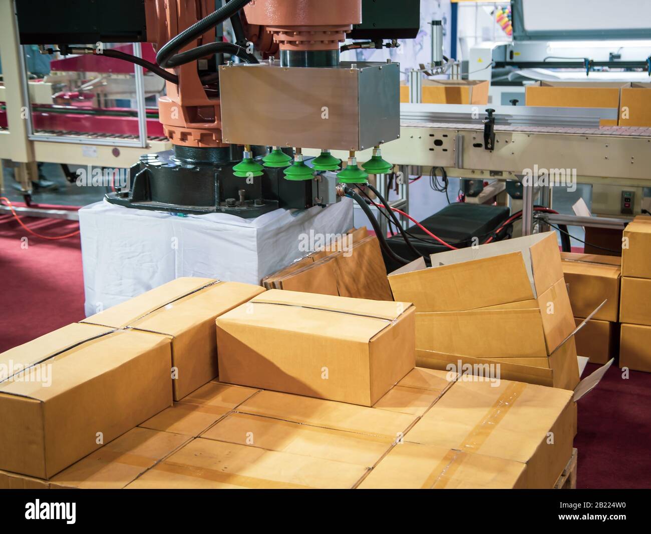 Universal Robot vacuum lifting cardboard in production line Stock Photo