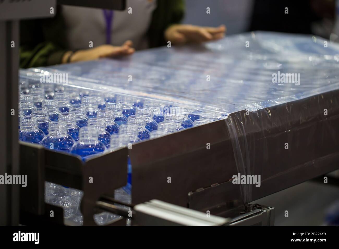 Production line packing empty plastic bottles in plastic bag Stock Photo