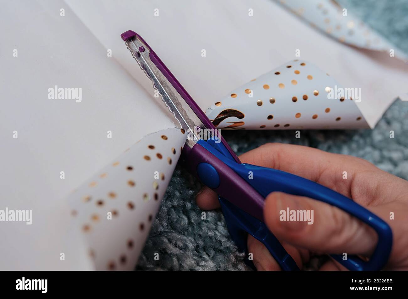 purple and blue curly scissors with an uneven decorated cut, scissors