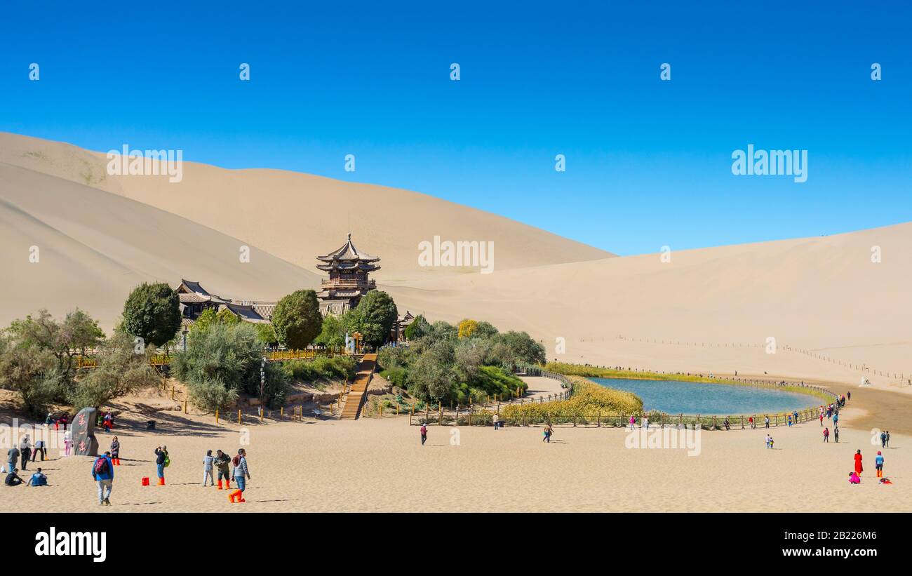 Beautiful mid morning at Crescent Moon Spring in Dunhuang, Gansu China, with tourists. Stock Photo
