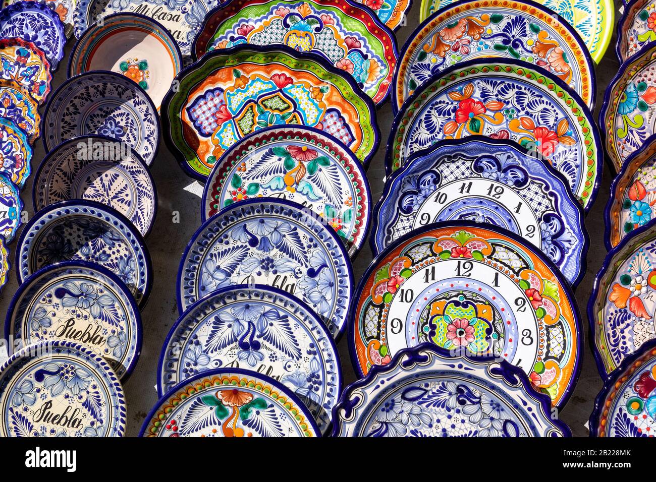 Colorful traditional Mexican pottery. Talavera style. Souvenirs on sale in local market of Puebla, Mexico. Stock Photo