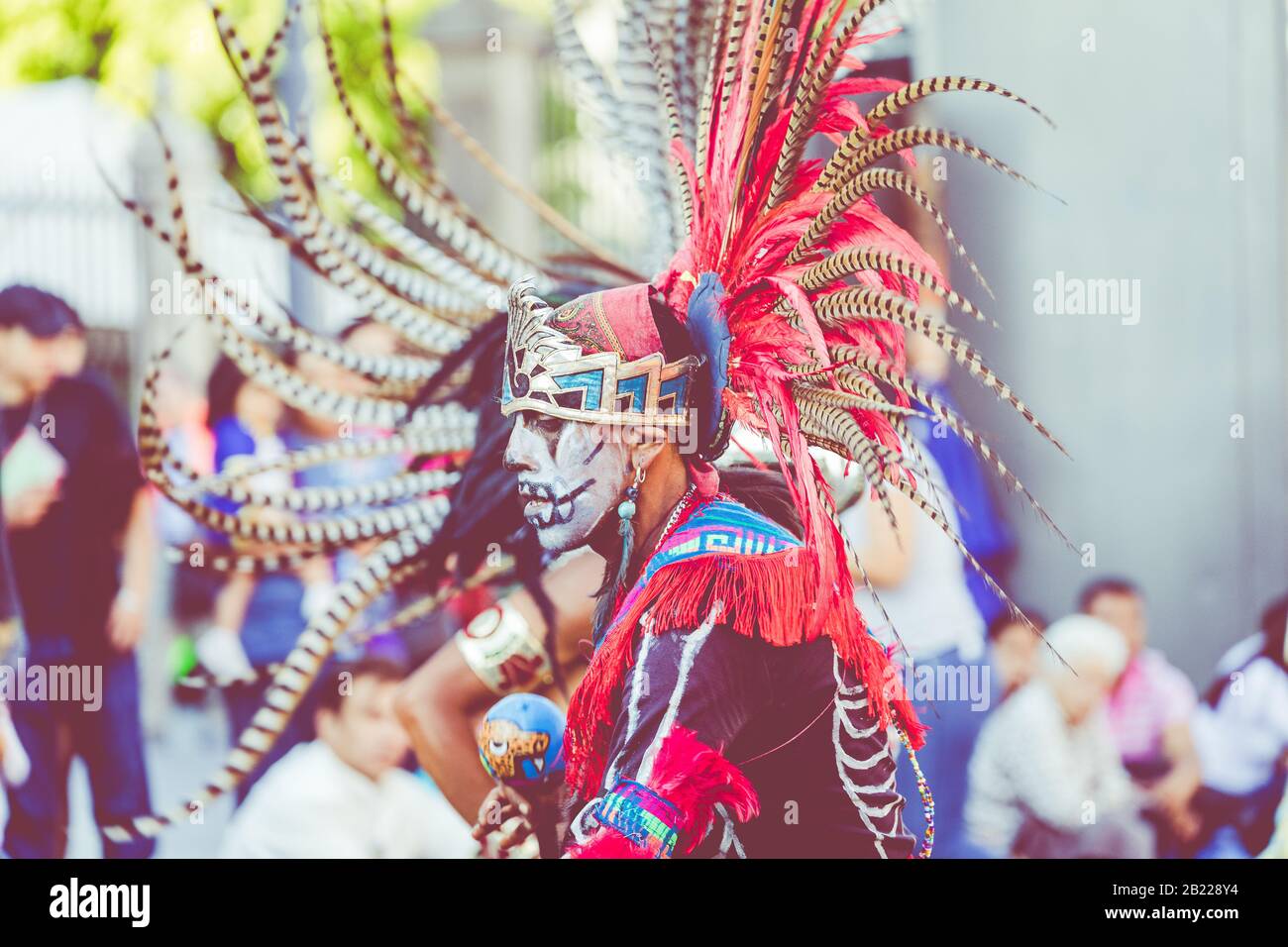 MEXICO CITY, MEXICO - FEBRUARY 17, 2020: Aztec dancers in traditional costumes dancing in the Zocalo in Mexico City, DF, Mexico. Stock Photo