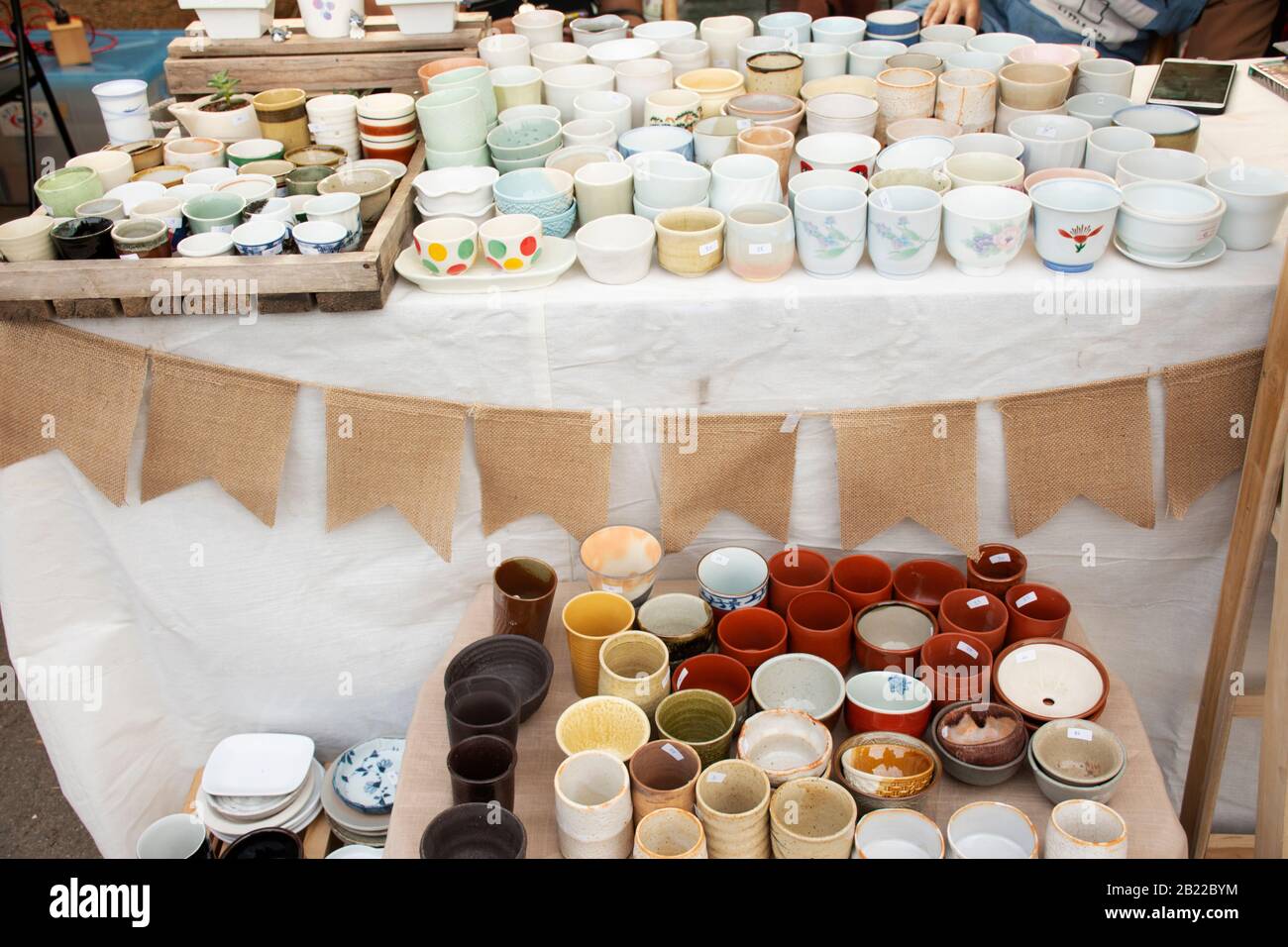 Sculpture ceramic tea cup and pot tea art for sale travelers people buy at street market in Bangkok, Thailand Stock Photo