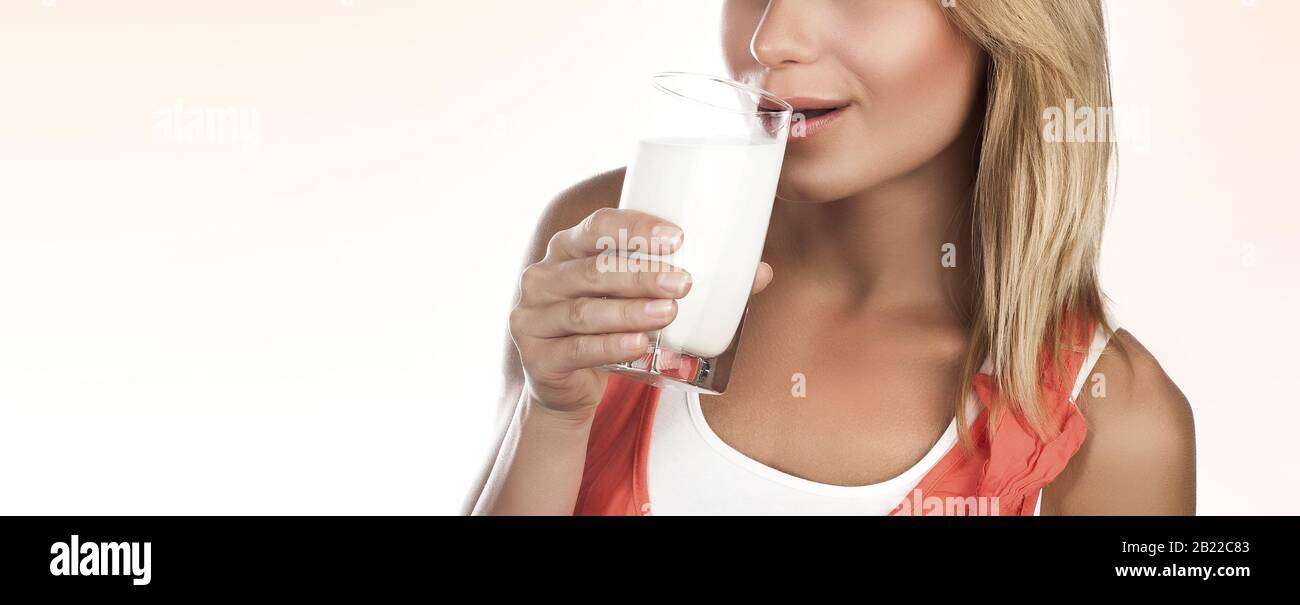 Portrait of a nice girl with glass of milk isolated on white background
