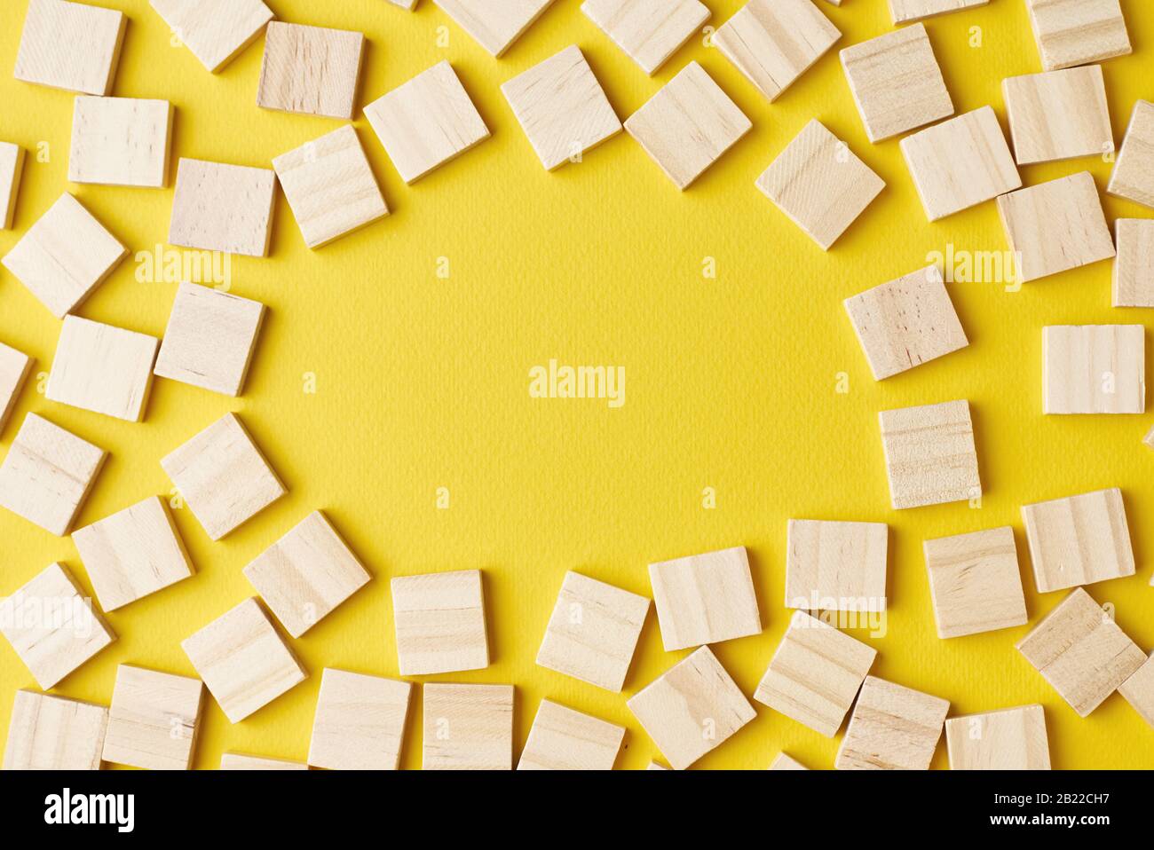 Empty wooden blocks pattern on yellow background with copy space, top ...