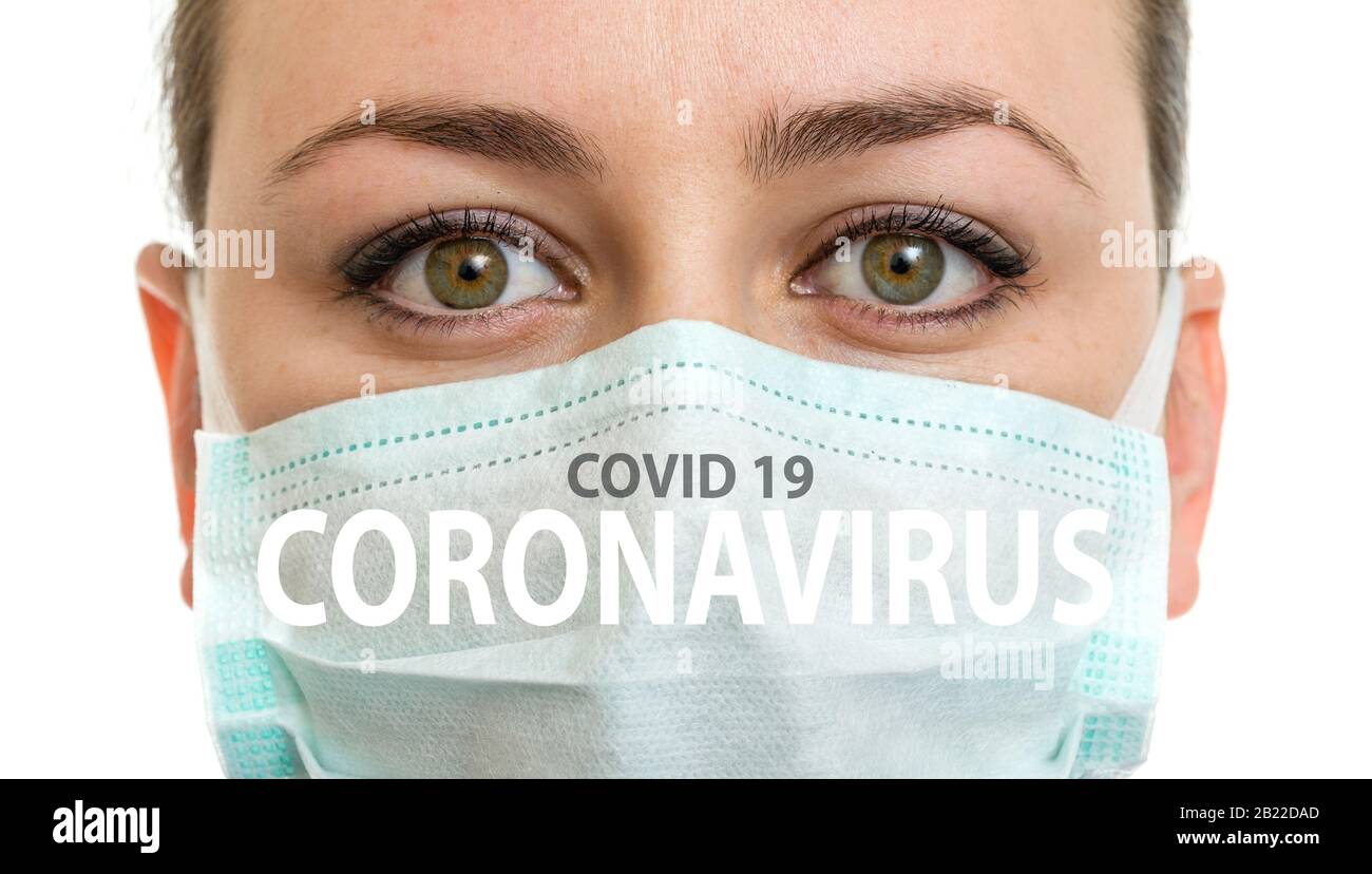 Medical mask on woman face with the inscription CORONAVIRUS , covid 19 Stock Photo