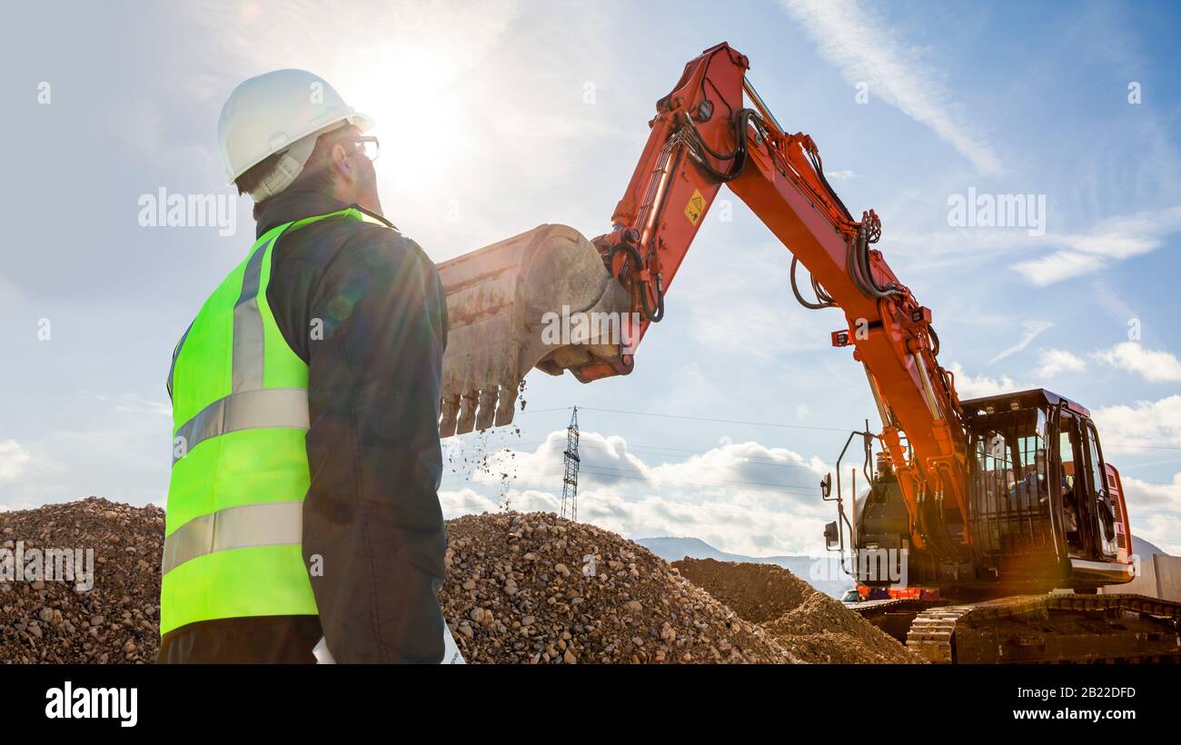 ecivil engineer foreman worker on construction site with excavator Stock Photo