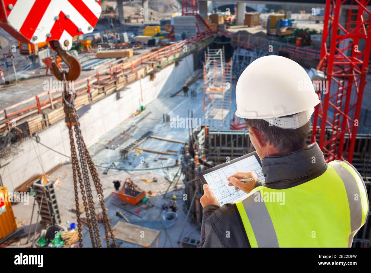 ecivil engineer foreman worker on construction site working on laptop tablet computer Stock Photo