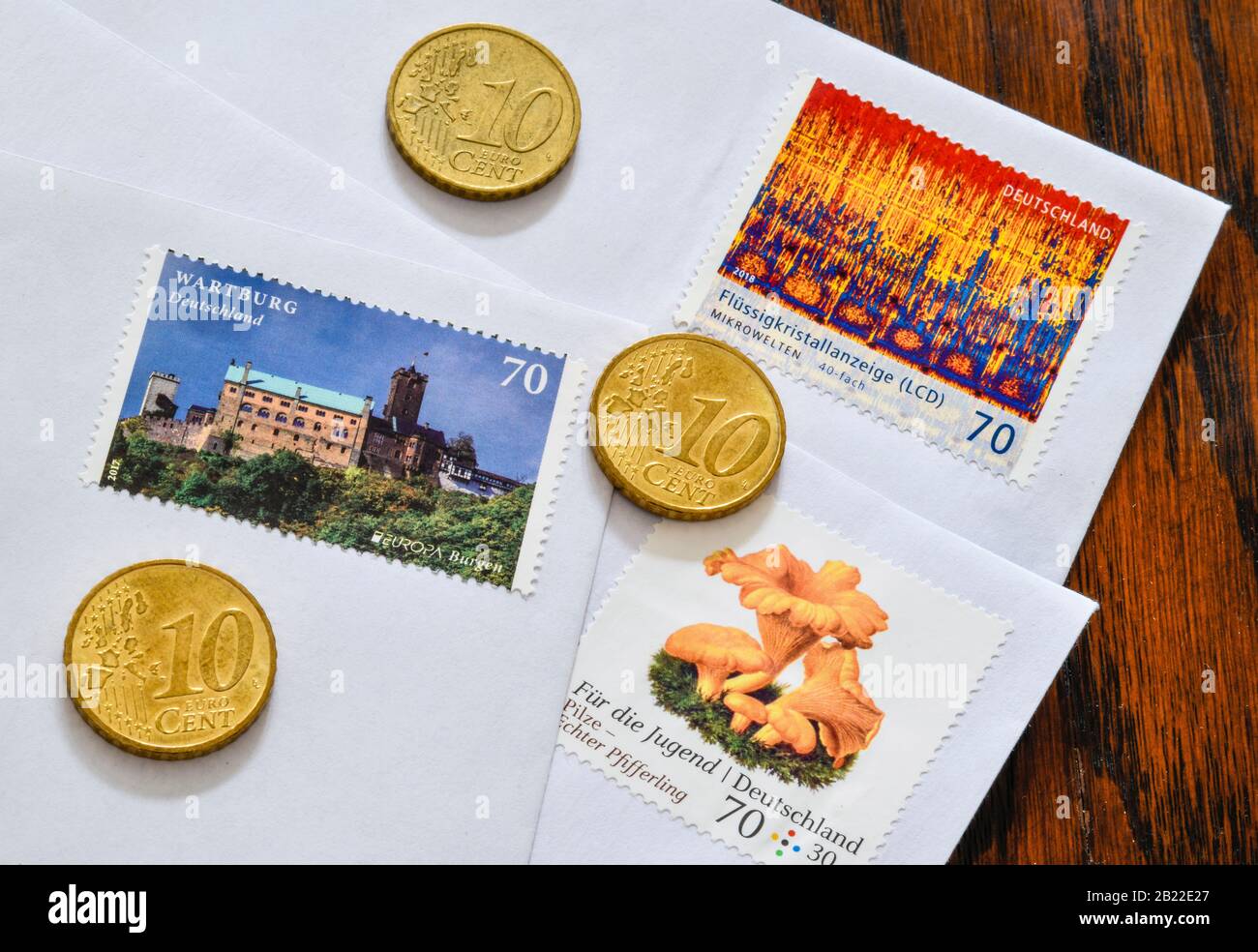 Deutsche Briefmarken 70 Cent und 10 Centmünzen, Symbolfoto Portoerhöhung Stock Photo