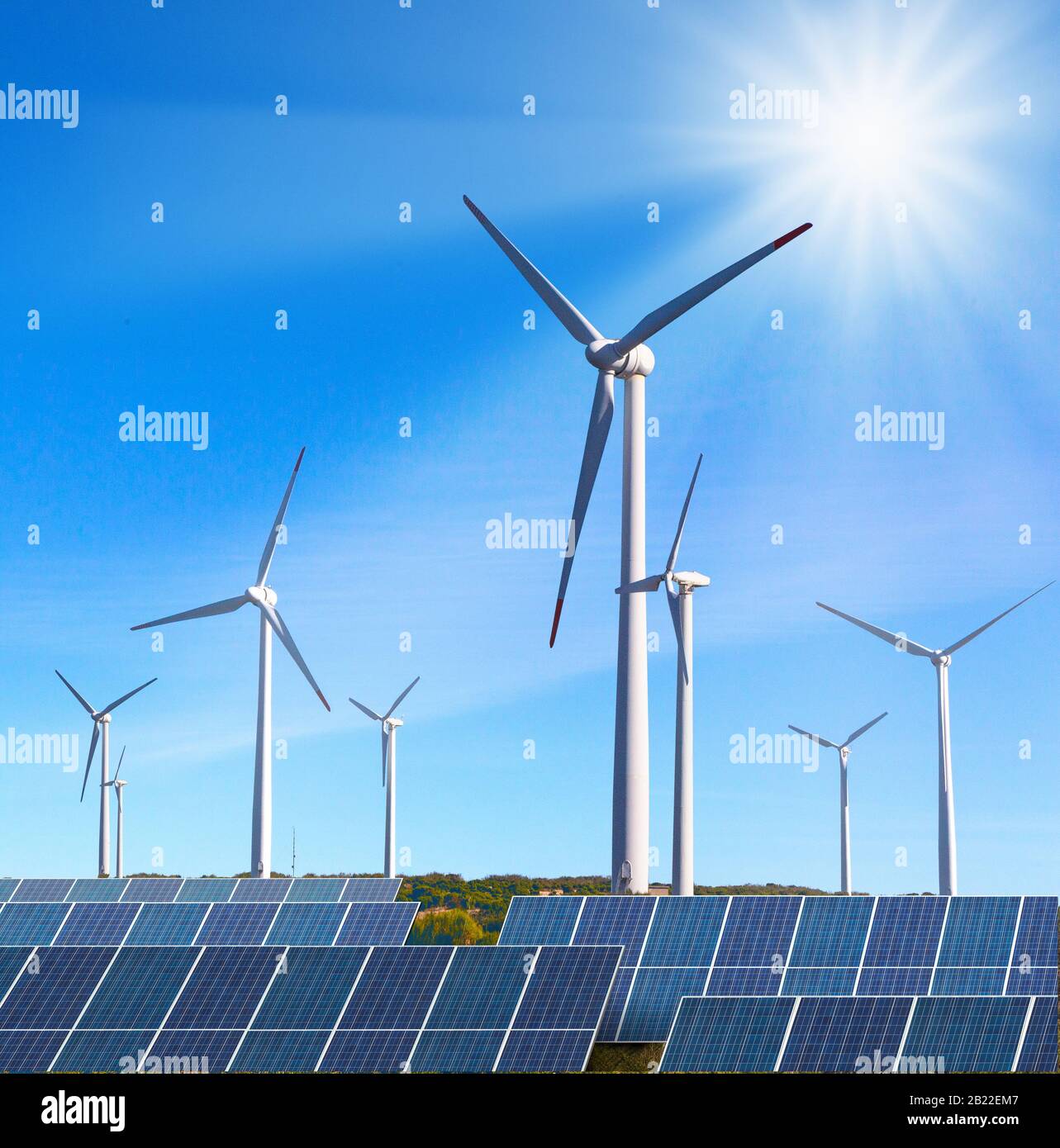solar panels with wind turbines against blue sky Stock Photo - Alamy