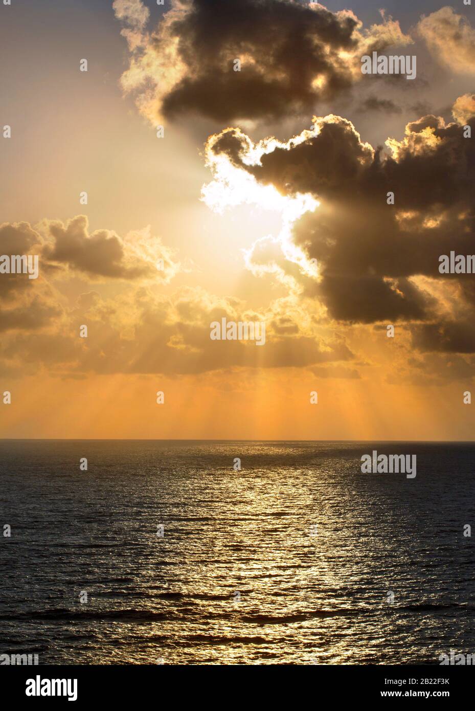 Sunset with sun rays and clouds Stock Photo - Alamy