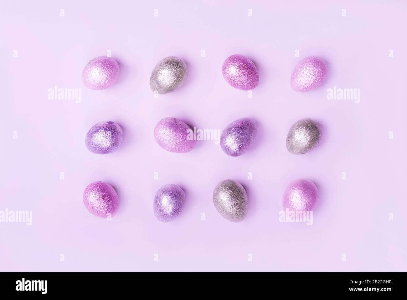 Colored painted pearl chicken and quail eggs of pink, silver, golden color Stock Photo