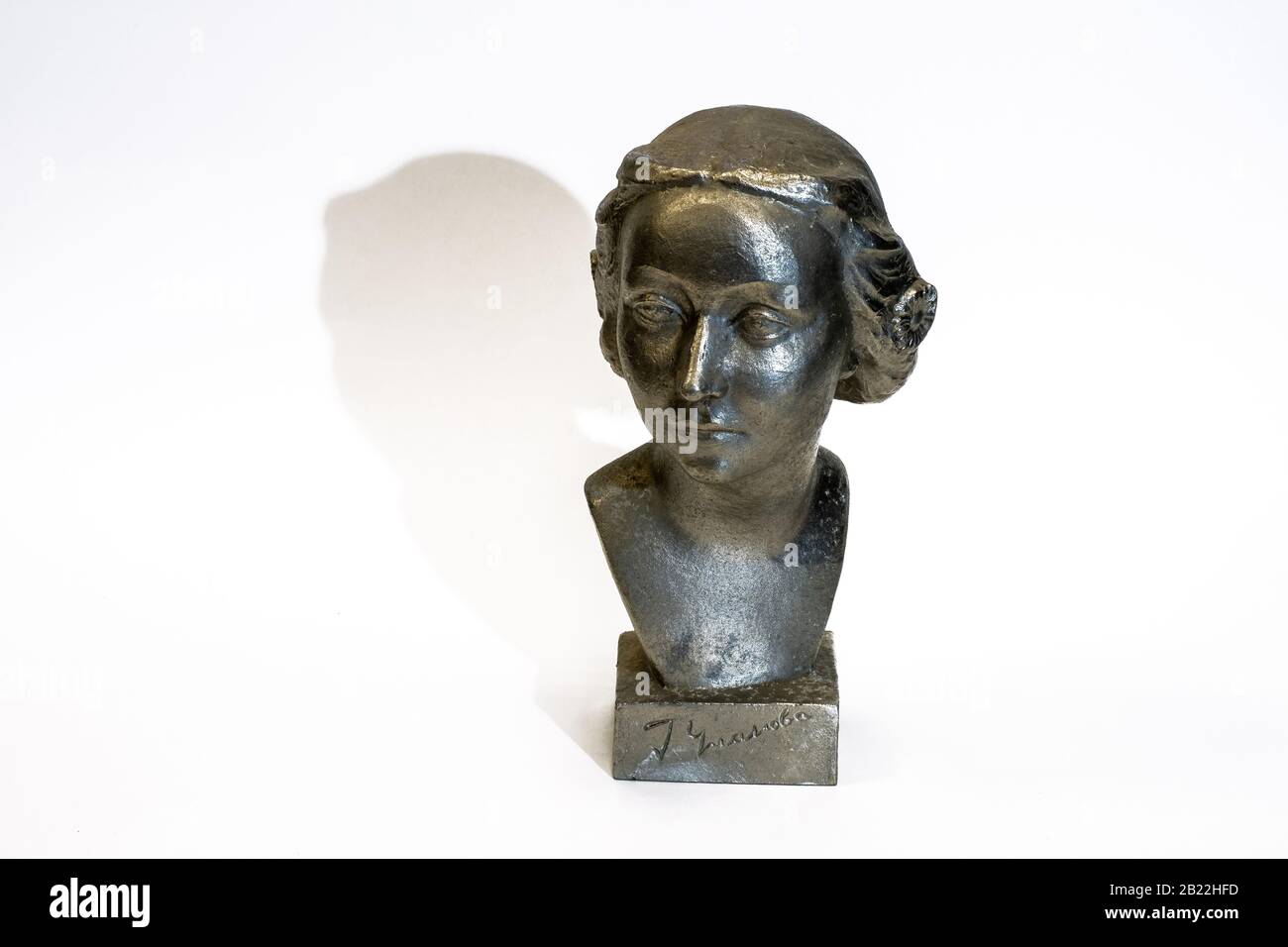 Small metal antique bust of the Soviet ballerina Galina Ulanova on a white background. Stock Photo