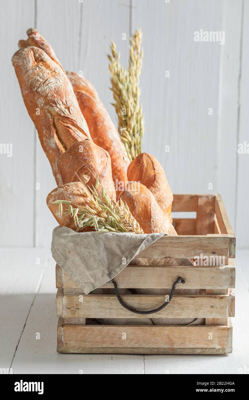 Rustic golden baguettes freshly baked in wooden box Stock Photo - Alamy