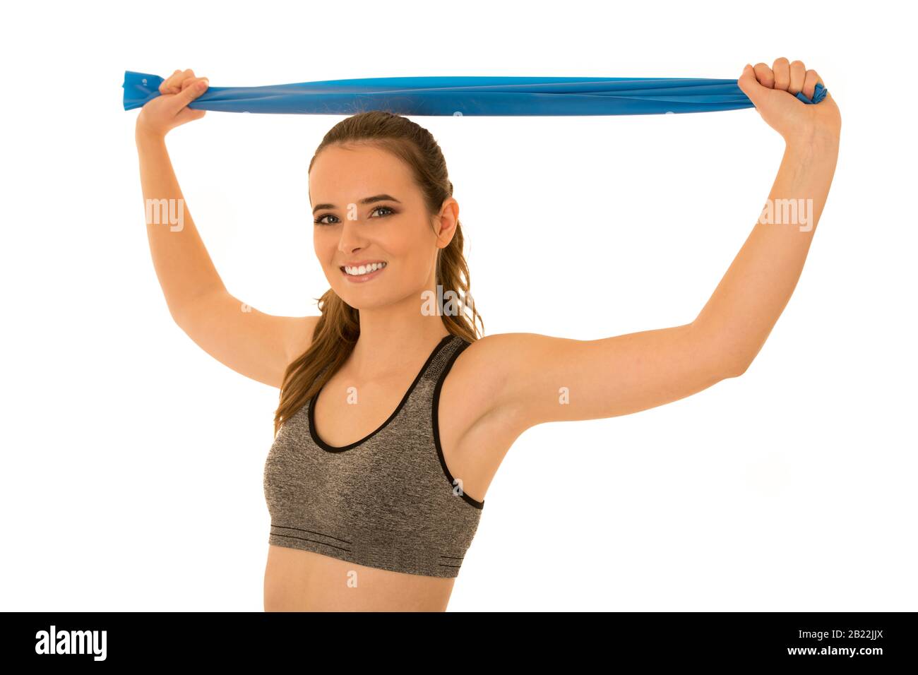 Beautiful fit woman works out with elastic band isolated over white ...