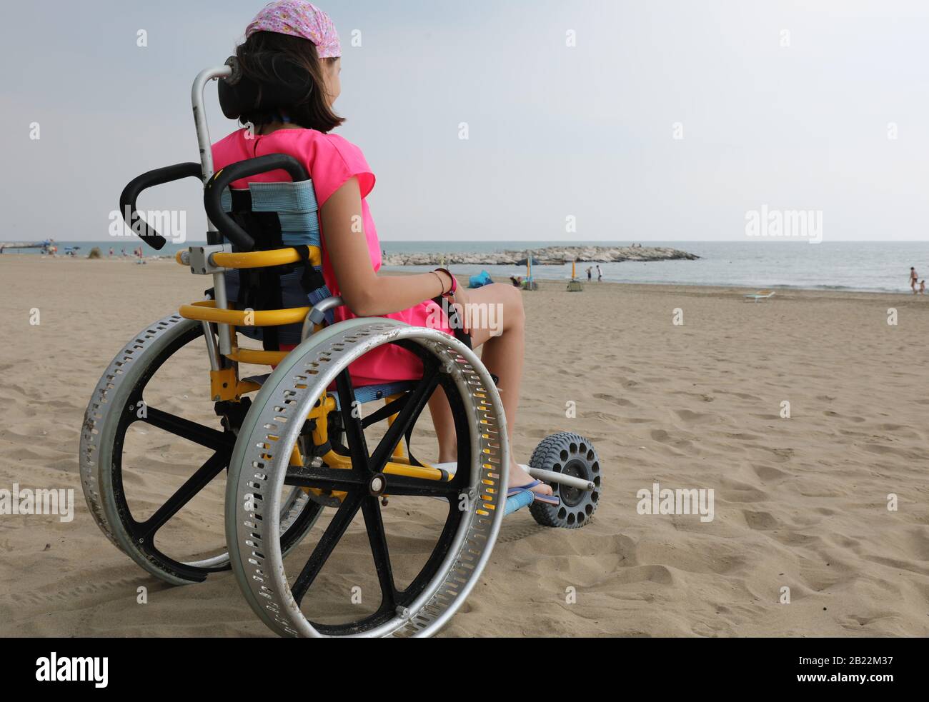 special wheelchair with big wheels in aluminium and a little girl in