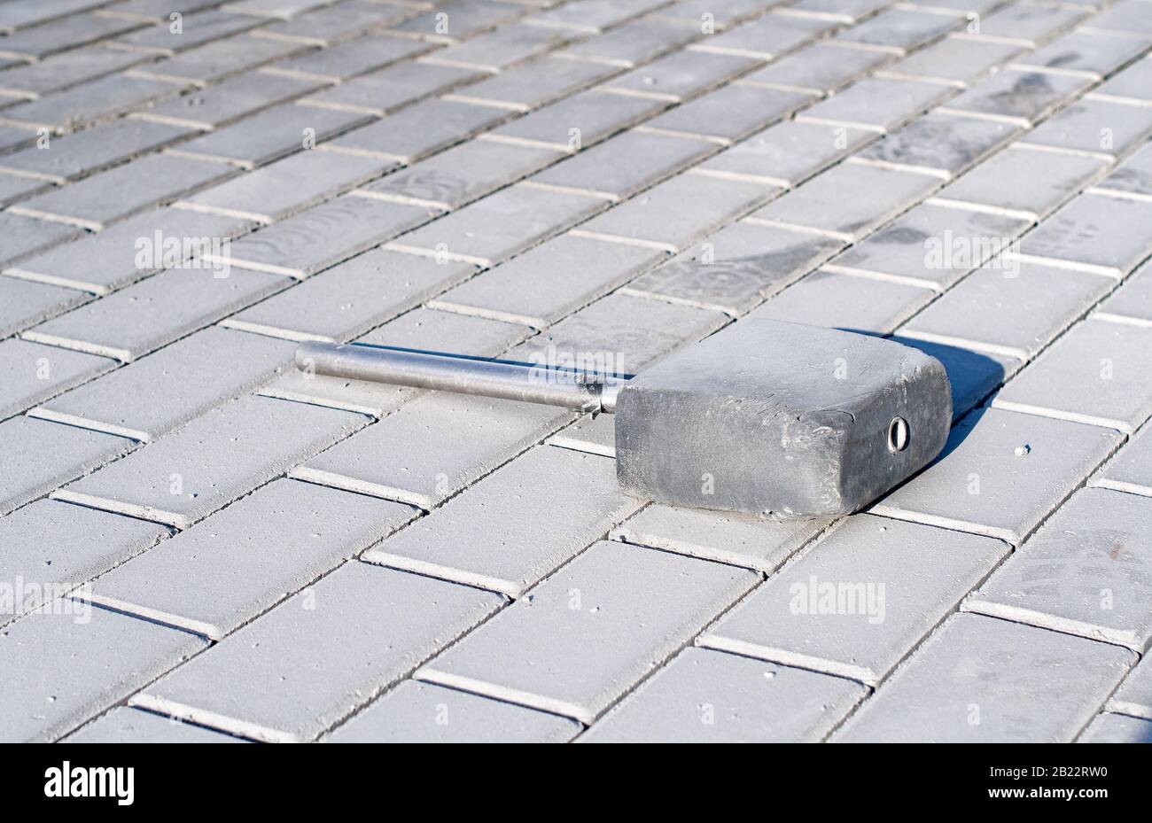 laying paving slabs. rubber mallet. Close up Stock Photo