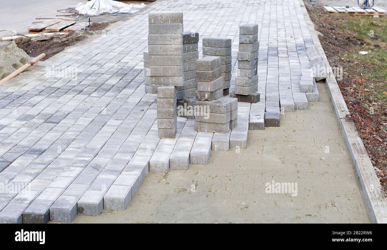 Concrete blocks and a curb are professionally installed on leveled sand