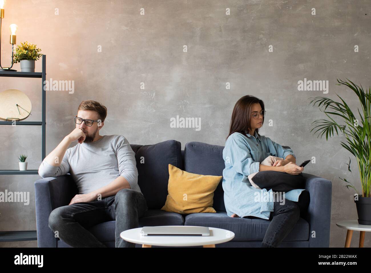 A young Couple are Sitting on the Couch After an Argument at Home. The ...