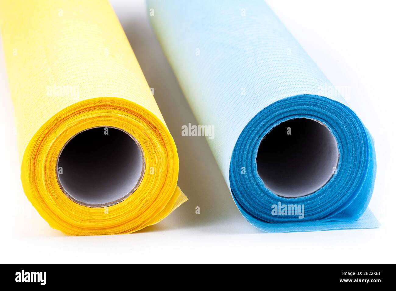 Simple new dental medical patient bibs, two rolls, yellow and blue on white, disposable bib water absorbing material, medical dental clinic safe clean Stock Photo