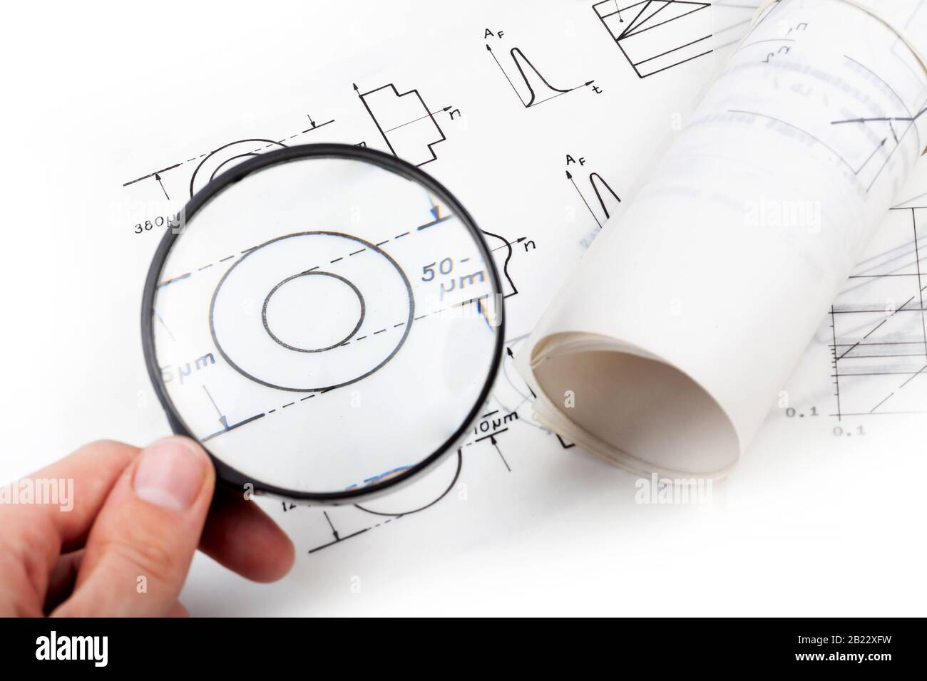 Man examining scientific papers, physics documentation fiber optics ...