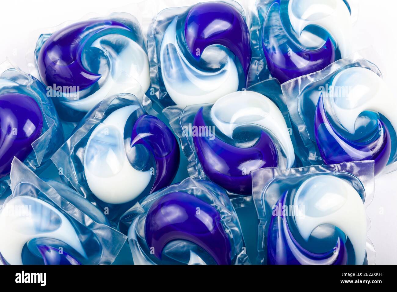 Many simple blue white detergent pods. Lots of washing machine pods