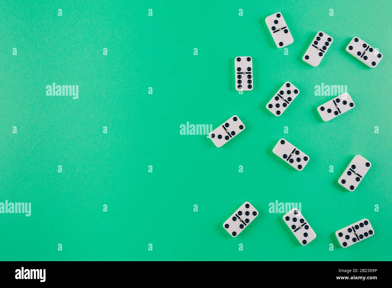 directly above shot of domino tiles on green background Stock Photo