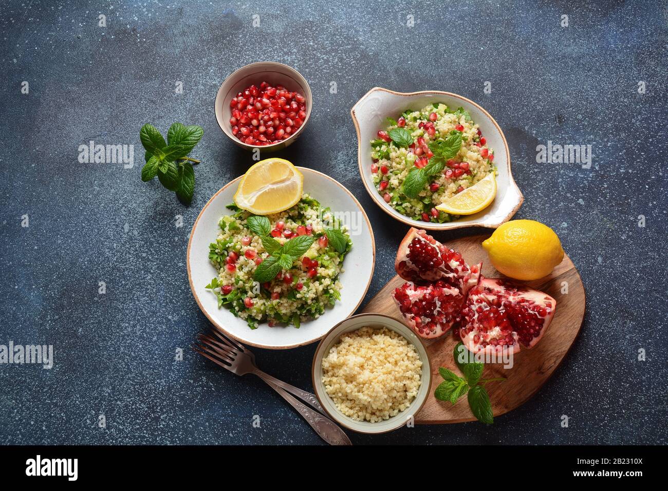 Healthy salad with couscous, fresh mint, cucumber, pomegranate, lemon and olive oil. Eastern
