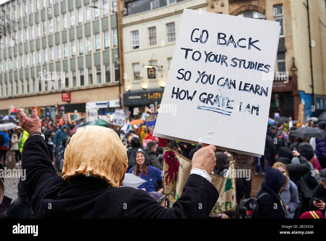 Man in a Donald Trump mask admonishing children for being on school strike on the Greta Thunberg March for Climate in Bristol UK Stock Photo