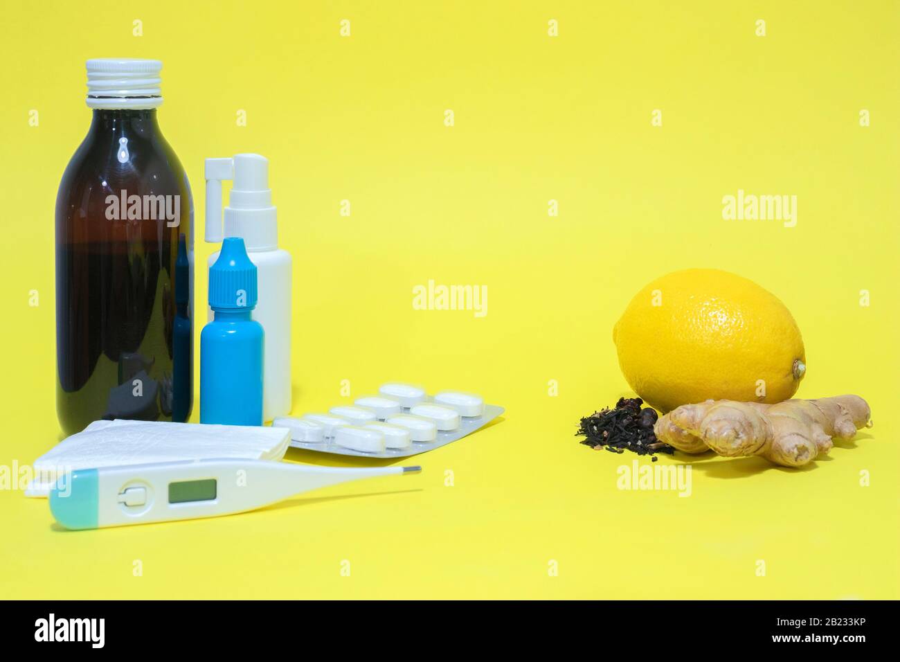 Natual remedies versus drugs and pills for curing flu and cold on yellow background Stock Photo