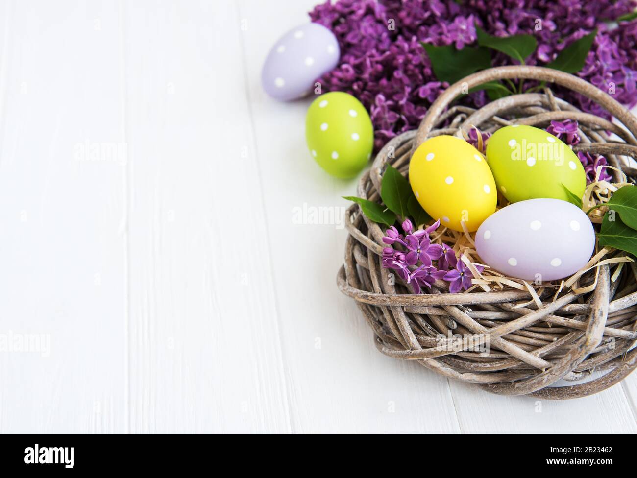 Nest with easter eggs and spring lilac flowers Stock Photo - Alamy