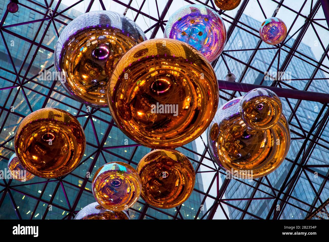 Bunch of Blue and Yellow Mylar Balloons with orange wall Stock Photo