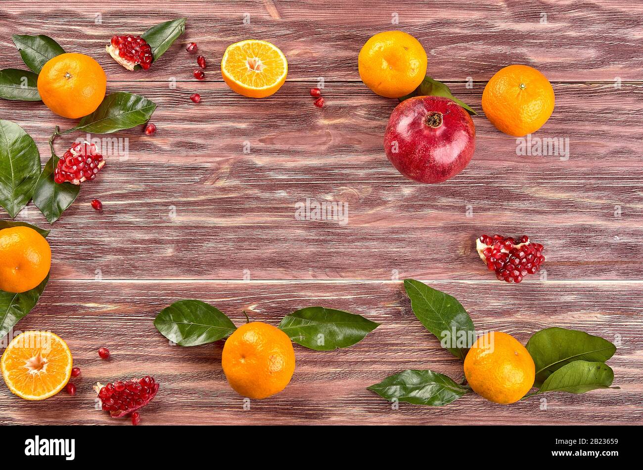 Still life with pomegranates and tangerines. Composition of ingredients (fruits) for making fresh juices. close-up. view from above Stock Photo