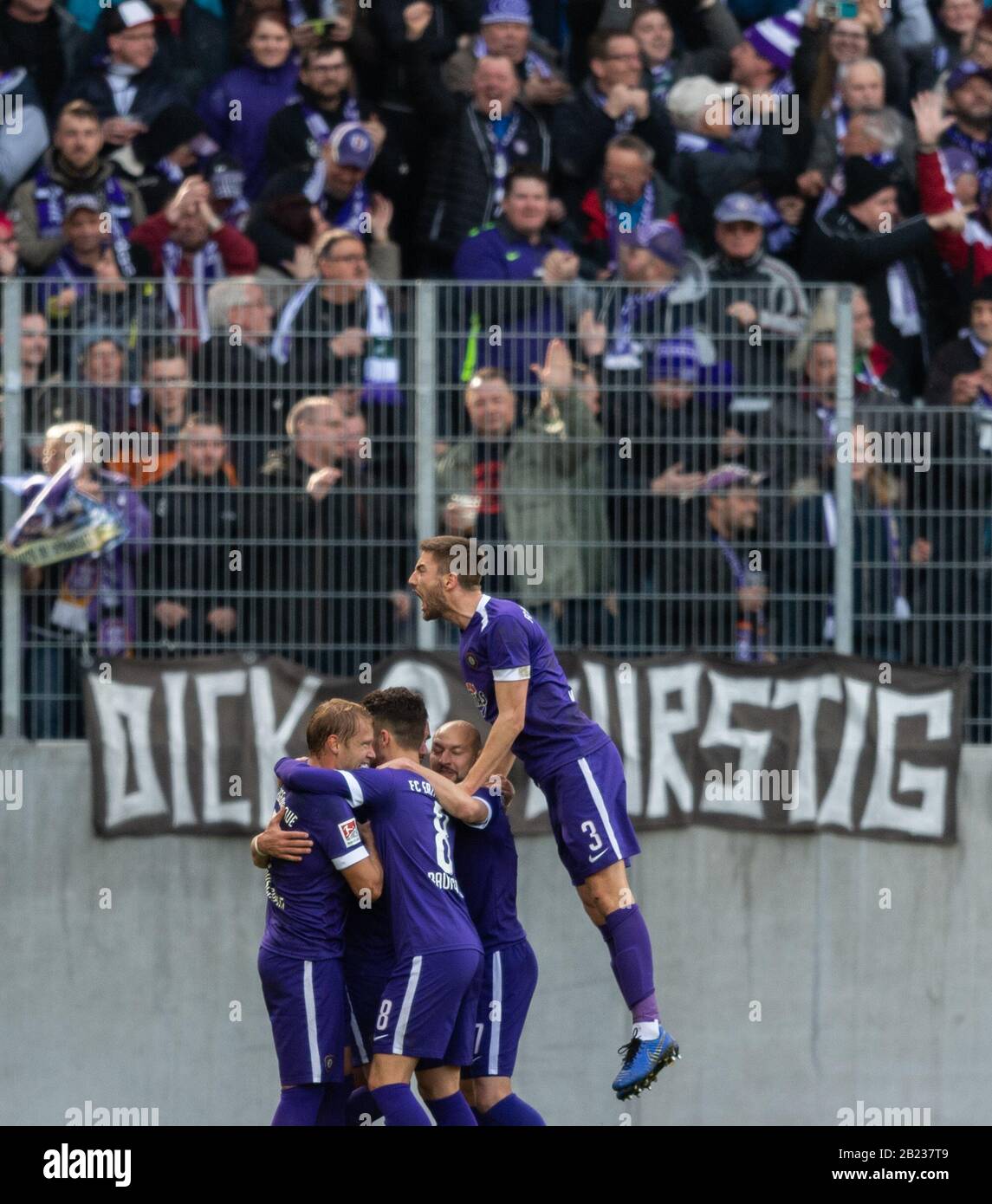 29 February 2020, Saxony, Aue: Football: 2nd Bundesliga, FC Erzgebirge Aue - Hamburger SV, 24th matchday, at the Sparkassen-Erzgebirgsstadion. Aues Pascal Testroet is cheered by his teammates Jan Hochscheidt (l-r), Tom Baumgart, Philipp Riese and Marko Mihojevic after his goal for the 1-0. Photo: Robert Michael/dpa-Zentralbild/dpa - IMPORTANT NOTE: In accordance with the regulations of the DFL Deutsche Fußball Liga and the DFB Deutscher Fußball-Bund, it is prohibited to exploit or have exploited in the stadium and/or from the game taken photographs in the form of sequence images and/or video-l Stock Photo