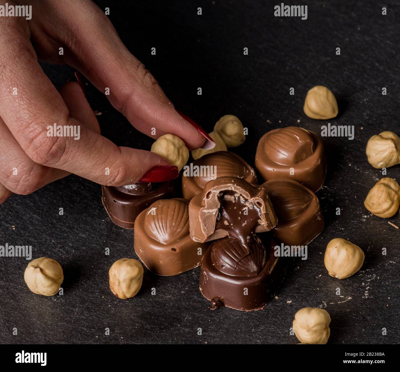 chocolatier pouring caramel filling into chocolate mold preparing handmade  candy Stock Photo - Alamy